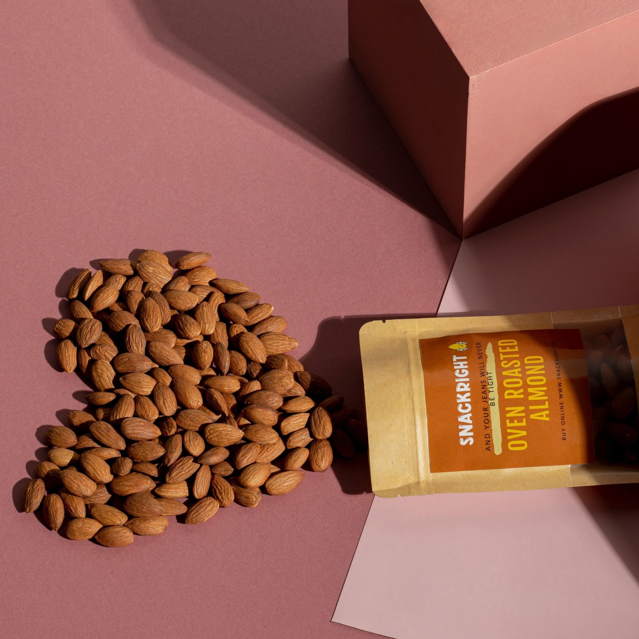 Heart Shape Oven Roasted Almond with a pink background in flat lay mode