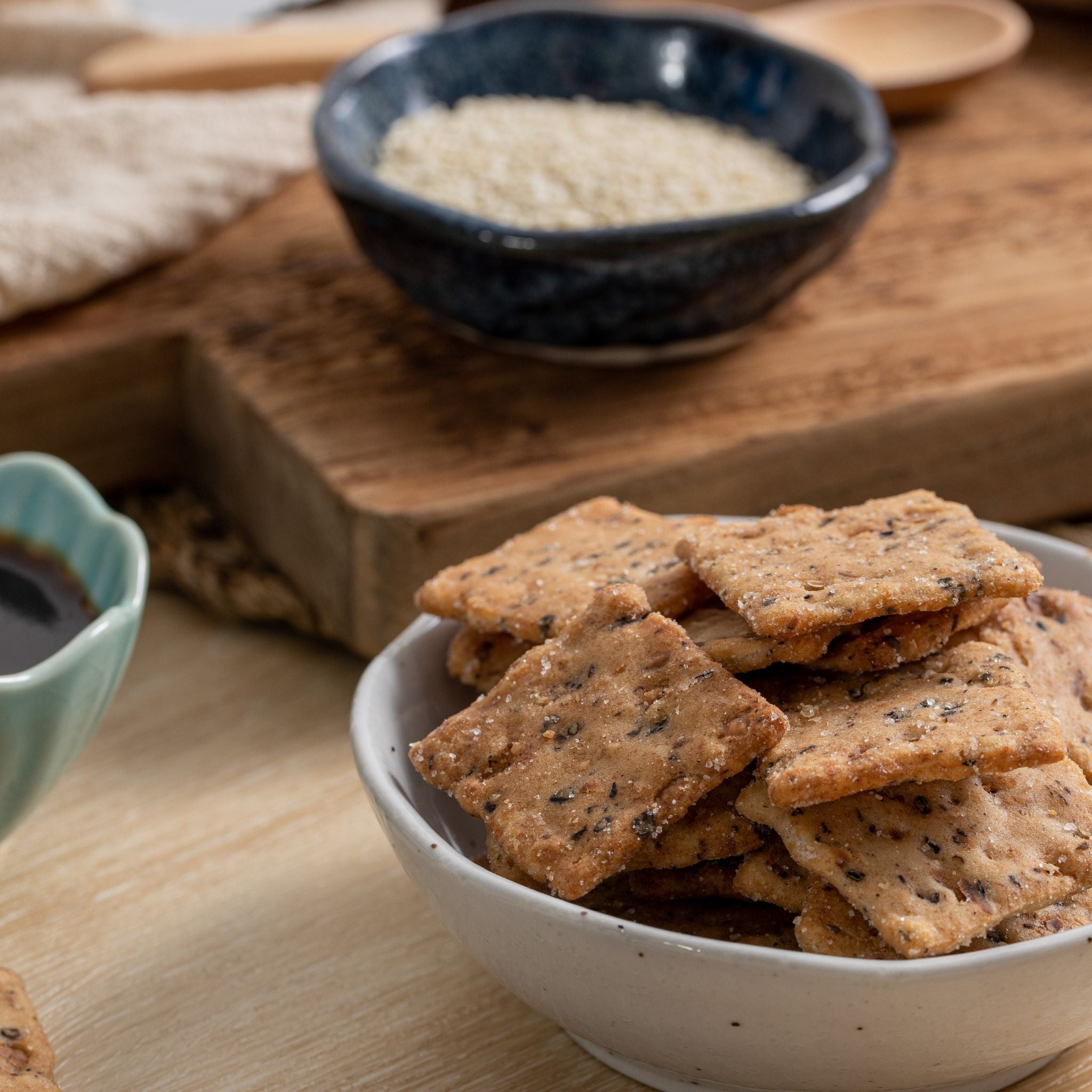 a bowl of Teriyaki Multigrain Rice Cracker with teriyaki sauce and quinoa aside 